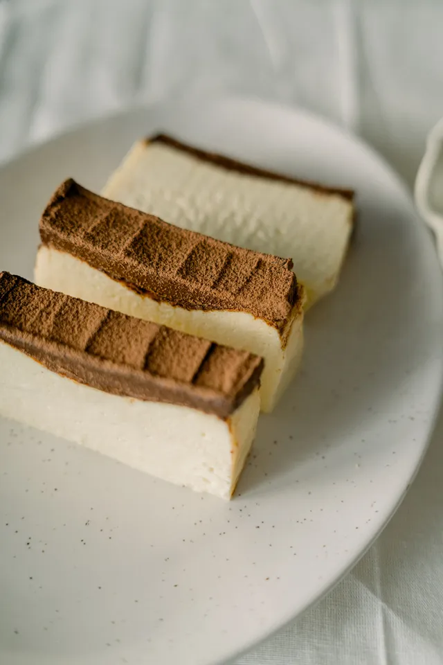 Nama Chocolate cheesecake slices with a dusted chocolate top