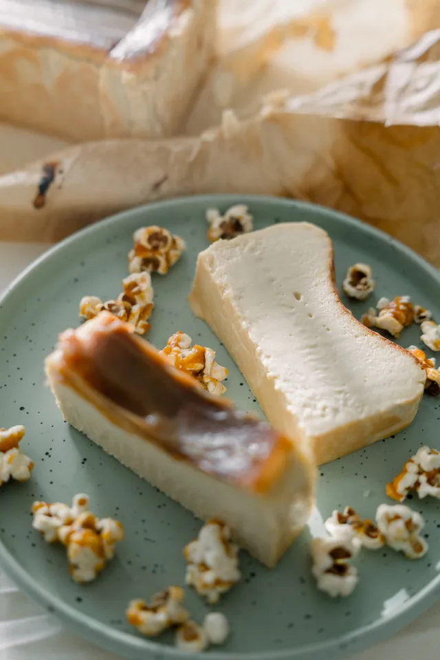 Salted Caramel cheesecake slices with caramel popcorn on a teal plate