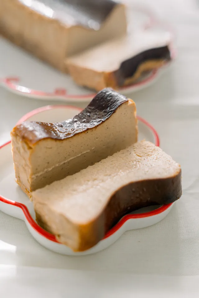 Thai Tea cheesecake slices on a red flower plate